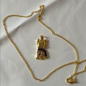 Gold and Black Pendant Necklace with Intricate Design